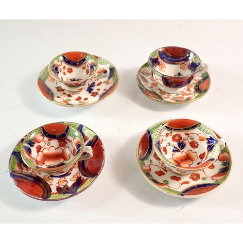 107 - A 19th century Gaudy Welsh set of four miniature cups and saucers (one saucer a/f)