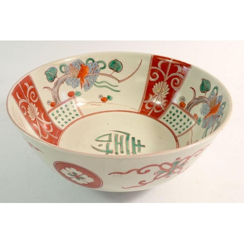 116 - A Chinese fruit bowl painted trees and stylised symbols, 22cm diameter