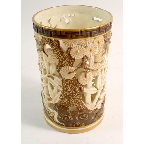 129 - A Royal Worcester Japanese style reticulated vase in ivory and gilt with bamboo and tree decoration,... 