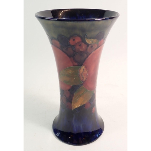 152 - A Moorcroft Pomegranate vase on green and blue ground 21.5cm tall