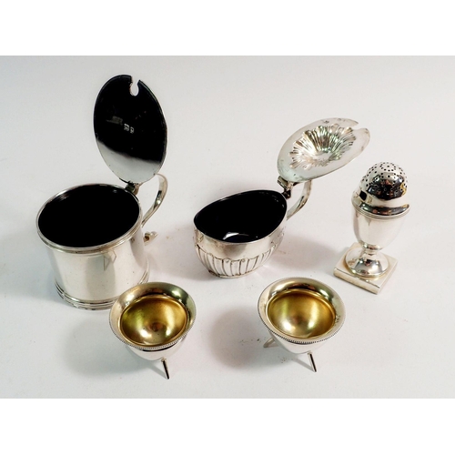 195 - A collection of silver cruets including two mustards with blue glass liners, Mappin & Webb pair of c... 