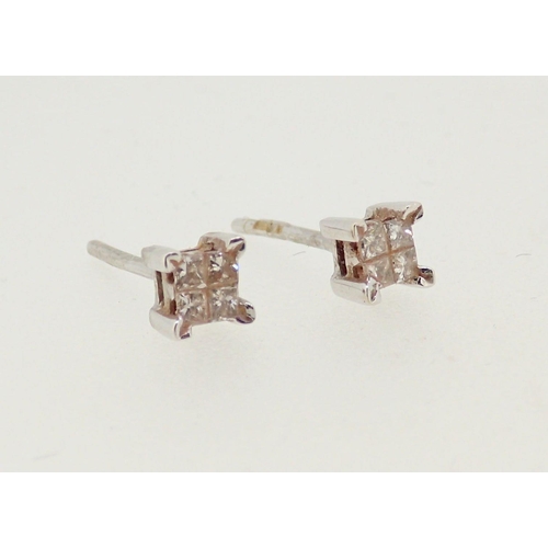 285 - A pair of 18 carat white gold earrings, each set four diamonds