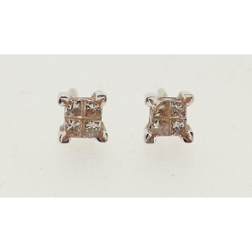 285 - A pair of 18 carat white gold earrings, each set four diamonds