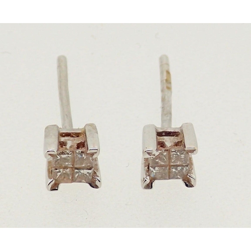 285 - A pair of 18 carat white gold earrings, each set four diamonds