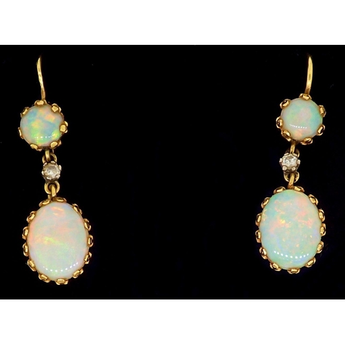 286 - A pair of 18 carat gold pendant earrings set opals and small diamonds