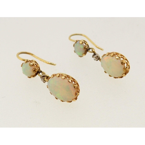 286 - A pair of 18 carat gold pendant earrings set opals and small diamonds