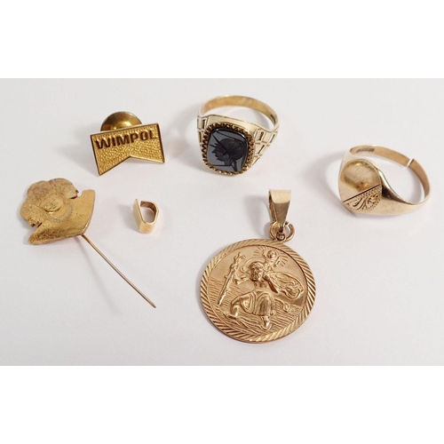 301 - A 9 carat gold St Christopher 3.9g, two 9 carat gold signet rings 6g, a 14 carat gold tie pin 2.2g a... 