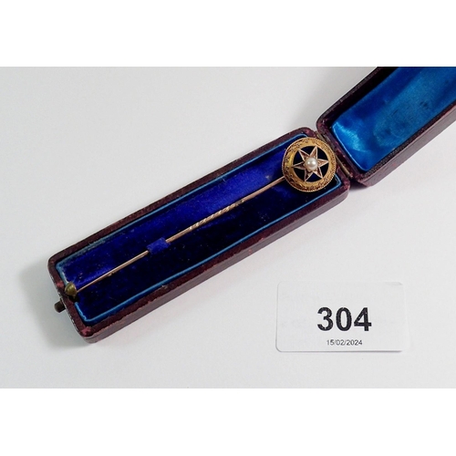 304 - A Victorian yellow metal stick pin with blue enamel and pearl star, cased