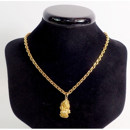 309 - A 22 carat rough cut gold nugget and chain, total weight 55.9g, chain 50cm long