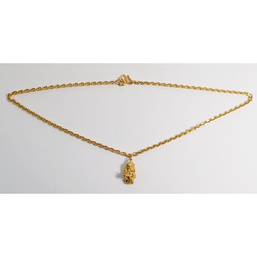 309 - A 22 carat rough cut gold nugget and chain, total weight 55.9g, chain 50cm long