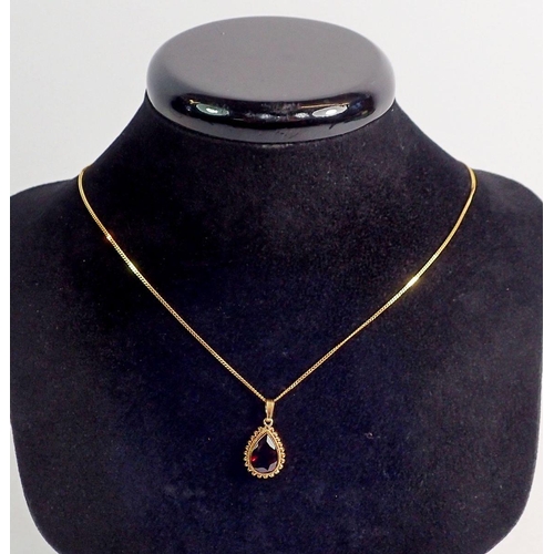 315 - A 9 carat gold garnet set pendant, 13mm drop and chain 44cm long - boxed