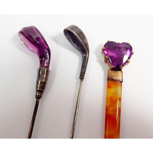 318 - A silver gold club hat pin and similar amethyst one plus an amber hairpin with heart from amethyst t... 