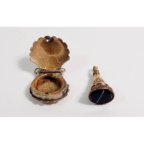 331 - An Edwardian yellow metal shell form locket and a small gold plated seal