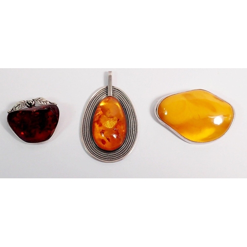 337 - Two silver mounted amber brooches and pendant, 6cm long