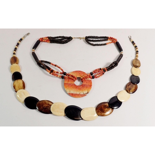 377 - A horn, ebony and bone necklace plus another bead necklace