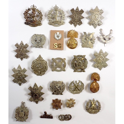 423 - A collection of Scottish military insignia, head-dress, collar badges, shoulder titles etc. black wa... 