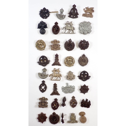 430 - A collection of 30 WWII plastic economy head dress badges, The Buffs, Glosters, The Welsh, Royal Wel... 