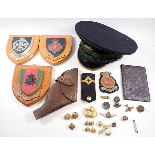 462 - A box of military items including Irish Guards cap and badge, leather pistol holder, copper spitfire... 