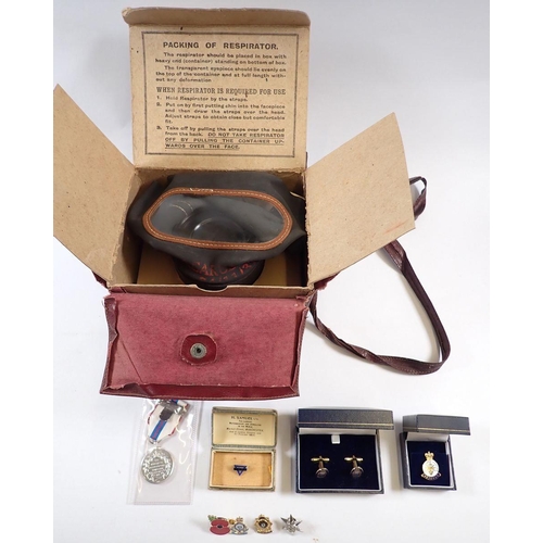 472 - A gas mask - boxed and various military enamel badges including YWCA