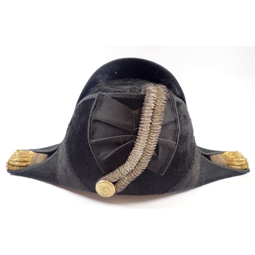 497 - A naval bicorn hat with gilt and silver braiding, silk lined interior, with tin box stamped J W Caru... 