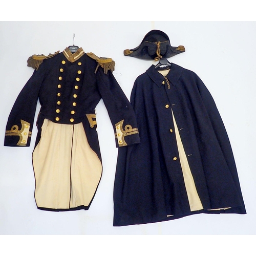 502 - A 19th century Naval officers uniform including bicorn hat, dress coat with epaulettes and a cape