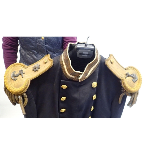 502 - A 19th century Naval officers uniform including bicorn hat, dress coat with epaulettes and a cape