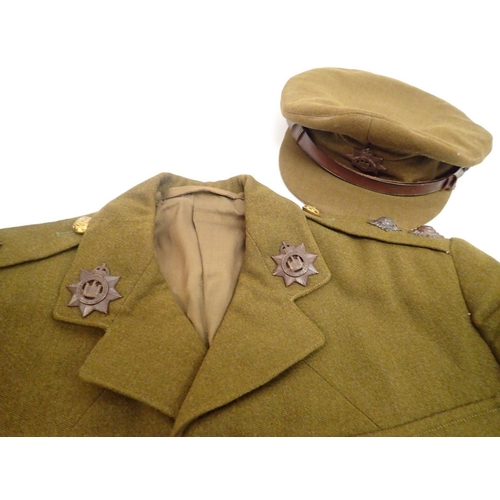 502A - A WWII uniform for Devonshire Regiment including two battle dress jackests, cap, Great Coat and para... 