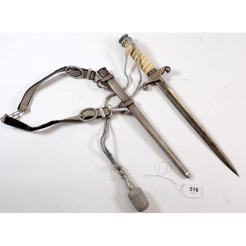 516 - A WWII German dagger with ivorine handle, the blade by Alcosa Solingen with sheath, straps and pomme... 