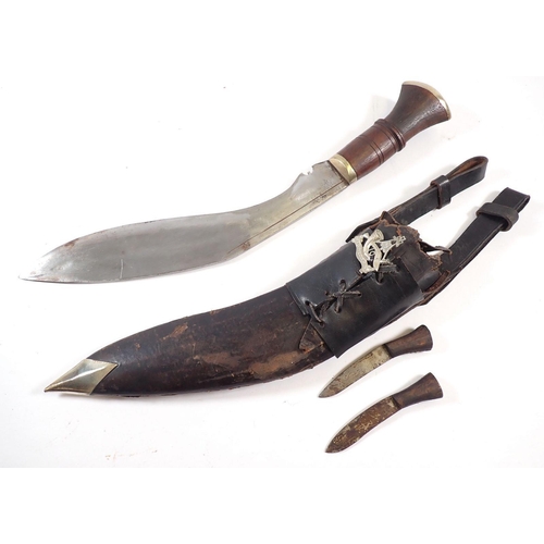 517 - A 20th century Gurkha Kukri knife with wooden grip in leather sheath with Frog and Karda and Chakmak... 