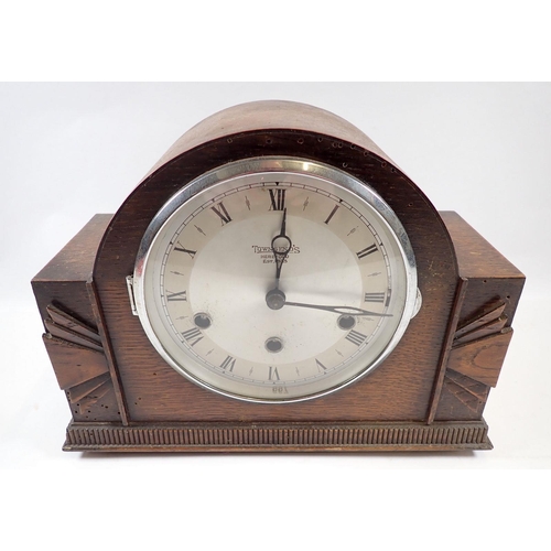 667 - An oak 1930's striking mantel clock retailed by Townsend's of Hereford