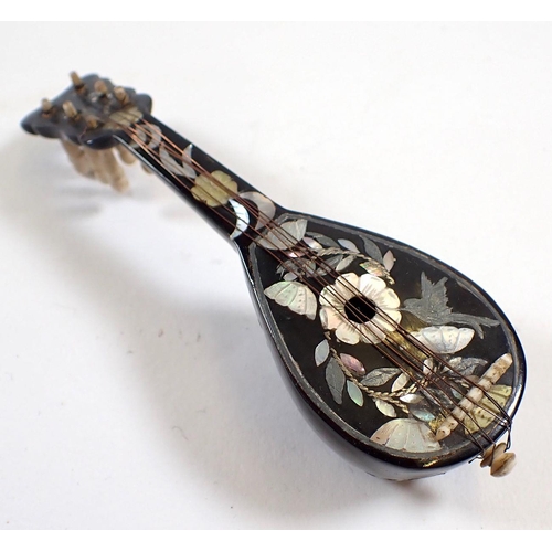 682 - A miniature tortoiseshell and mother of pearl miniature mandolin with bird and flower inlay and bone... 