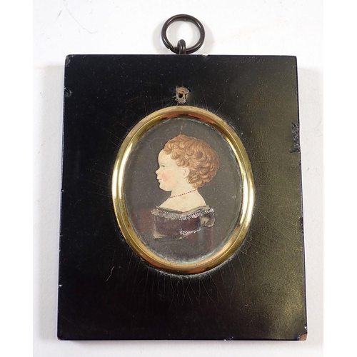 698 - A watercolour cut out miniature of a young girl in 17th century dress, 5.5 x 4.5cm