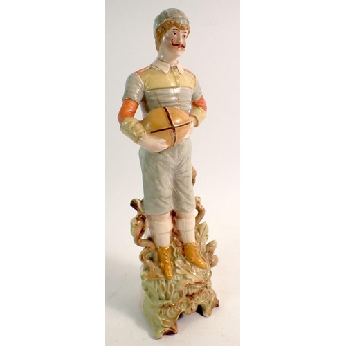 70 - A 19th century bisque porcelain figure in form of a rugby player, 22.5cm tall