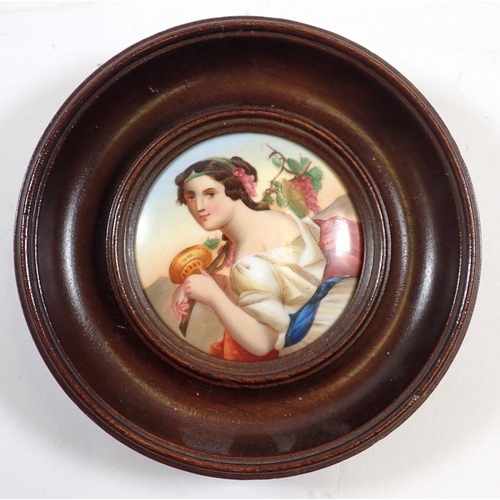 702 - A 19th century painting on porcelain miniature of an Italian woman with vines, 6.5cm diameter