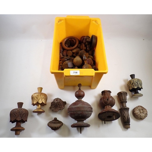 716 - A box of carved treen door knobs, finials etc.