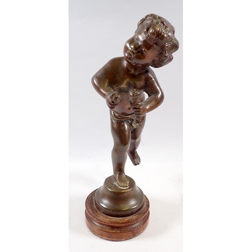 719 - A bronze figure of cupid on stand, 26cm tall