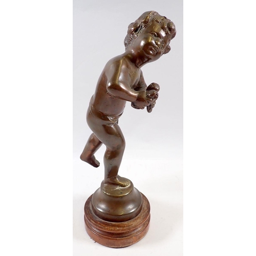 719 - A bronze figure of cupid on stand, 26cm tall