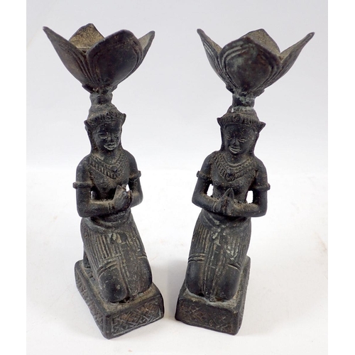 723 - A pair of Egyptian brass candlesticks in the form of kneeling praying women, 15.5cm