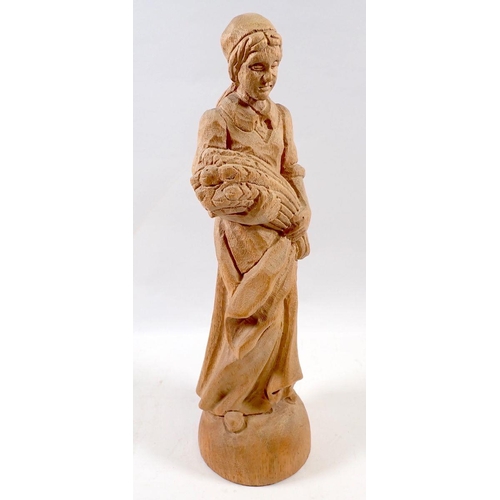 724 - A carved wooden figure of a woman with wheatsheaf, 30cm tall