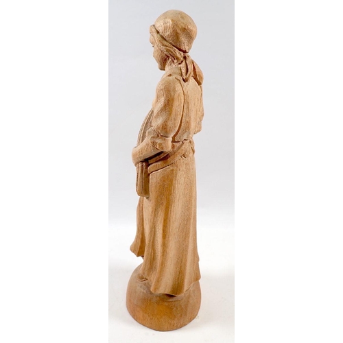 724 - A carved wooden figure of a woman with wheatsheaf, 30cm tall