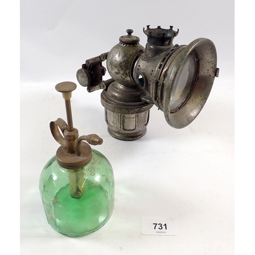 731 - A carbide early car lamp and a green glass oil can