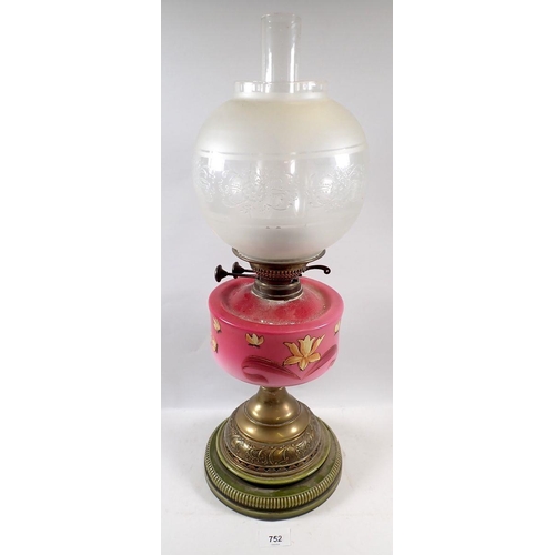 752 - A Victorian oil lamp with pink floral painted glass reservoir, stoneware and brass base and etched g... 