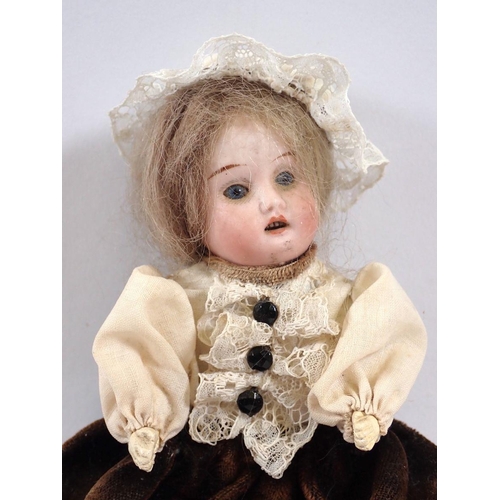 757 - A Victorian bisque headed small doll with porcelain legs, 16cm