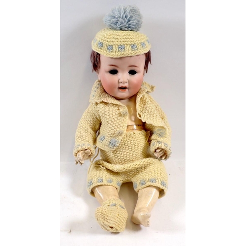 761 - A bisque headed composition doll with cry voice box - a/f, eyes loose, open mouth with teeth and red... 