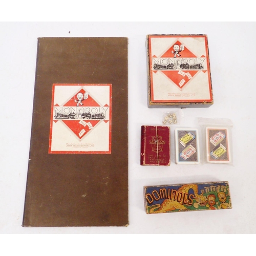 767 - A group of old games including 1930's dominoes and Lexicon and 1940's Monopoly and board and two pac... 