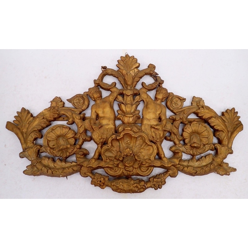 797 - An antique large carved wood and gilt gesso decorative over lintel crest depicting satyrs amid flowe... 