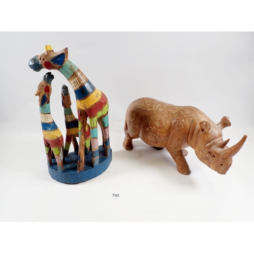 798 - A large carved wood rhinoceros, 16cm tall and a painted giraffe group