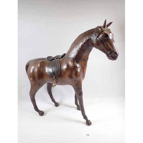 799 - A vintage Liberty style  leather over wood model of a horse with glass eyes, 52cm tall