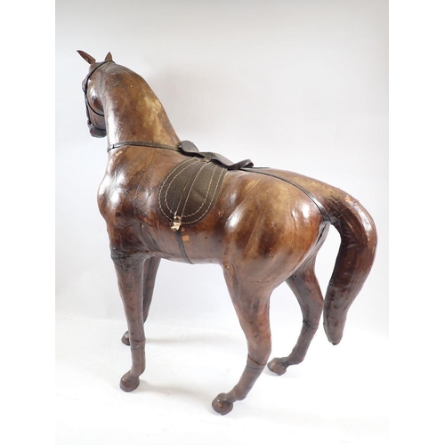 799 - A vintage Liberty style  leather over wood model of a horse with glass eyes, 52cm tall