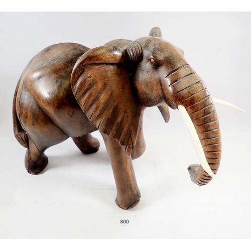 800 - A large carved African elephant with simulated ivory tusks, 32cm tall